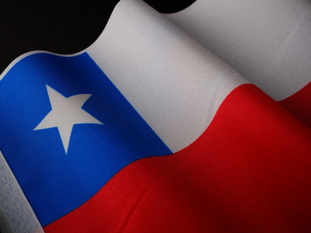 Detailed close-up of the Chilean national flag with vibrant colors and texture.